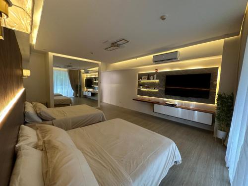 纳苏格布The Beach Suites at Pico De Loro的酒店客房设有两张床和一台平面电视。