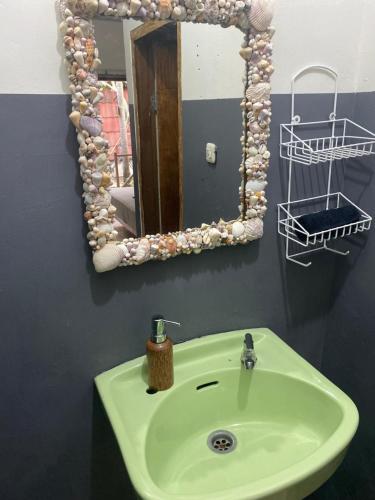 吉利特拉旺安Bintang Guesthouse的浴室配有带镜子的盥洗盆和镜子