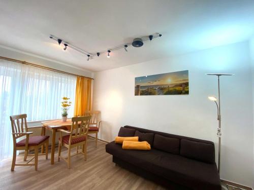 诺因多夫Süderhaus Hiddensee App 4的带沙发和餐桌的客厅