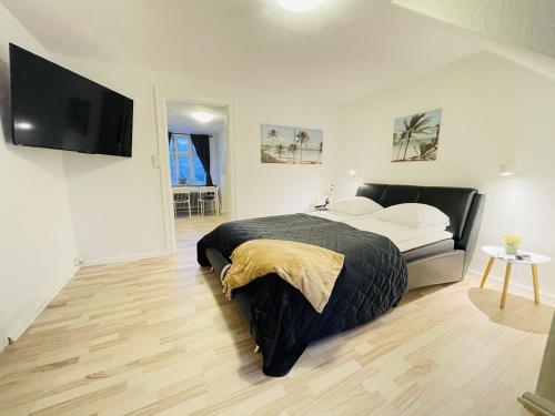 兰讷斯aday - Randers Elegant and Trendy Apartment的一间卧室配有一张床和一台平面电视