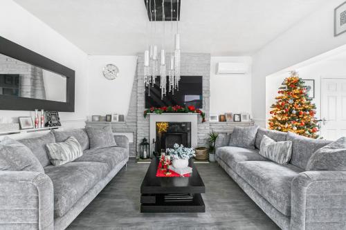 莫尔西Hampton Oasis with Heated Pool & Large Garden的带沙发和圣诞树的客厅