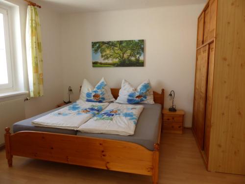 马里亚霍夫沃莱瑟乡村民宿的一间卧室配有一张带蓝色和白色枕头的床