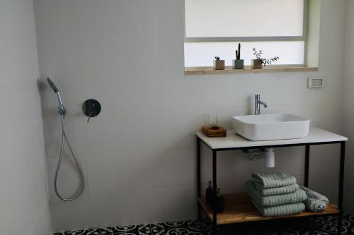 Jaba‘בקתות האס ואטינגר的白色的浴室设有水槽和镜子