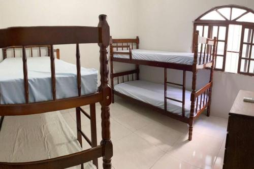 丰当Casa Excelente Praia Grande的一间卧室设有两张双层床和一张桌子