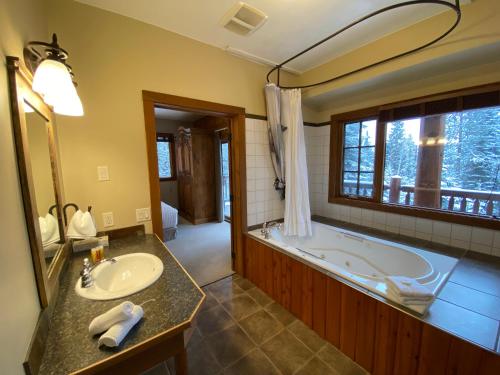 戈尔登温斯顿旅馆的带浴缸、水槽和镜子的浴室
