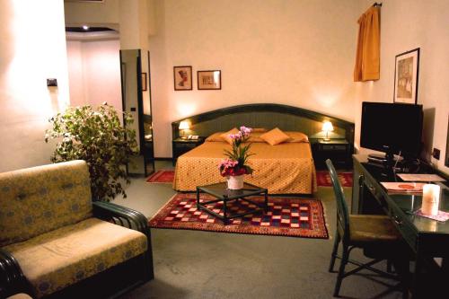 Vedelago安蒂卡波斯图米亚酒店的卧室配有1张床、1张桌子和1把椅子