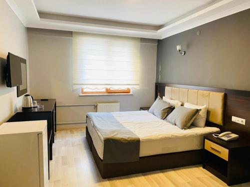 安卡拉Animos Butik Otel的一间卧室配有一张床和一台电视