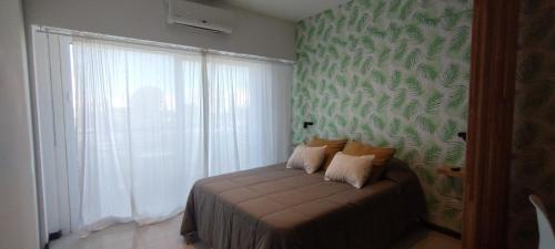 布宜诺斯艾利斯Balcón de lecheros的一间卧室配有一张带绿色墙壁的床