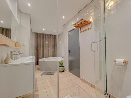 约翰内斯堡Amoris Guesthouse - Sandton的带浴缸、水槽和淋浴的浴室