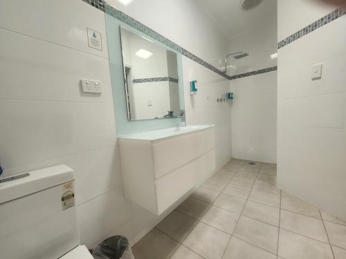 瑟尔24Seven汽车旅馆及公寓的白色的浴室设有水槽和镜子