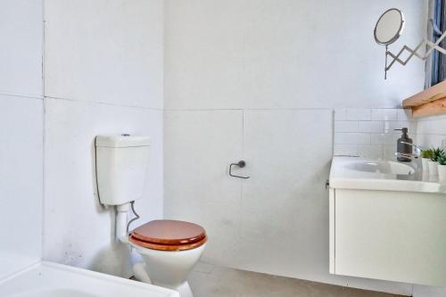 悉尼Unique 2 Bedroom House Pyrmont 2 E-Bikes Included的白色的浴室设有卫生间和水槽。