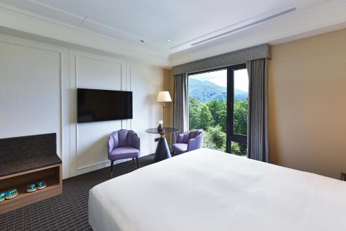 水里乡福容徕旅 水里的酒店客房设有一张床和一个大窗户