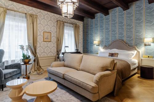 克拉科夫Hotel Unicus Palace Old Town的客厅配有床和沙发