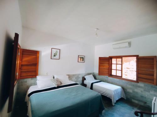 皮雷诺波利斯Recanto Rocas的一间卧室设有两张床和窗户。