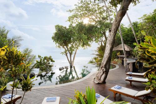BalianThe Cove Bali by Nakula的海景木制甲板,配有椅子