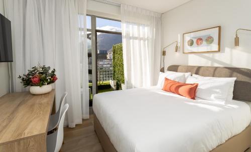 开普敦Habitat Aparthotel by Totalstay的卧室设有一张白色大床和一扇窗户。