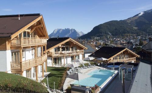 蒂罗尔-泽费尔德Mountains Hotel的一座带游泳池和度假村的建筑