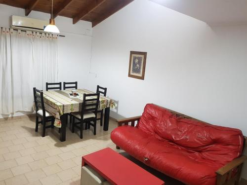 圣罗莎La esquina - Alquiler temporario的客厅配有红色的沙发和桌子