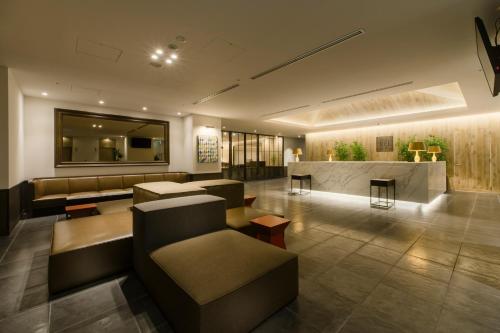 长野长野东急REI饭店的大厅配有沙发,大楼内设有一间酒吧