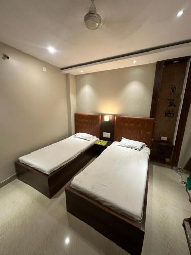 RourkelaHotel Punjab的一间客房内配有两张床的房间