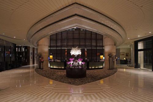曼谷曼谷阿索克希尔顿酒店 - Hilton Bangkok Grande Asoke的大厅,在大楼中间插花