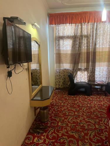 马拉里Sana Challet Manali的客厅配有平面电视和镜子