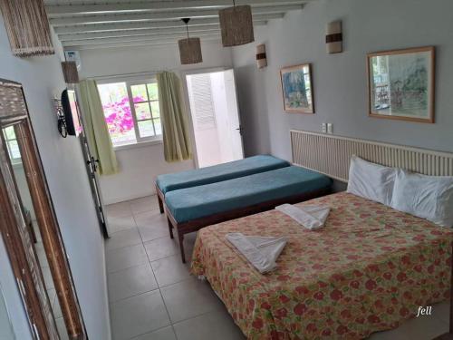 普拉亚多Apart Hotel Forte Blu的酒店客房设有两张床和窗户。