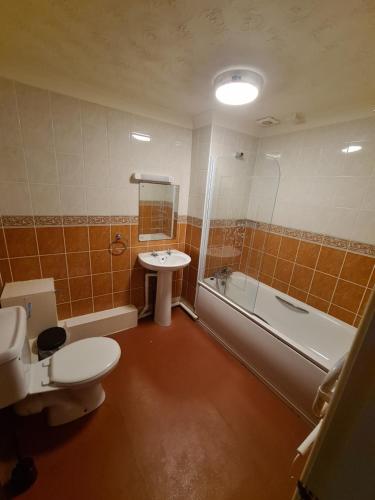 伯恩茅斯Devon Towers Hotel的浴室配有卫生间、盥洗盆和浴缸。