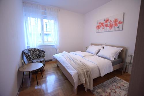 萨莫博尔Apartman Gajeva的卧室配有床、椅子和窗户。