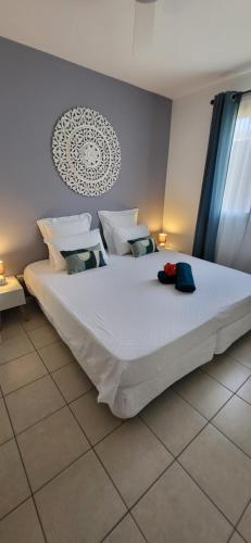 拉萨尔勒班VILLA THALIA à 300 m du lagon de la Saline les Bains的卧室配有一张带白色床单和枕头的大床。