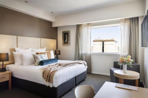 基督城Fable Christchurch的酒店客房设有一张大床和一张书桌。