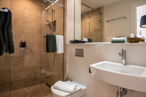 马略卡岛帕尔马帕尔马套房酒店的带淋浴、盥洗盆和卫生间的浴室