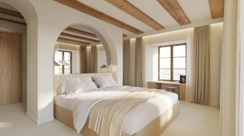 圣于尔萨讷Hôtel de La Cigogne的卧室配有一张大白床和大镜子