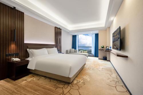 花都广州白云机场嘉宇酒店的卧室设有白色的床和大窗户