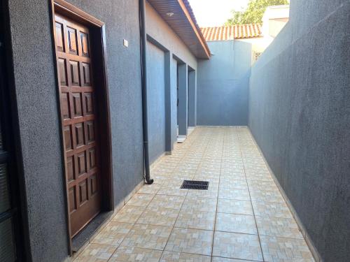 AndiráCasa de Andirá的一条空的走廊,有门,铺着瓷砖地板