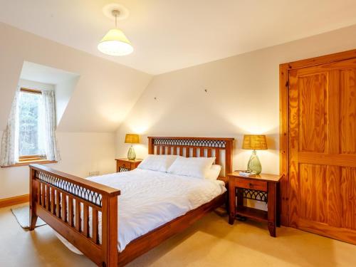 Strath4 Bed in Badachro CA390的一间卧室配有一张带2个床头柜和2盏灯的床。