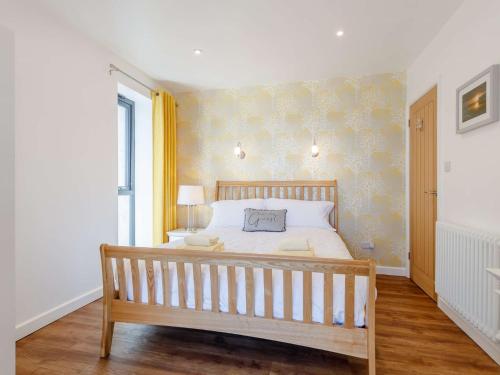 滨海韦斯顿1 Bed in Weston-Super-Mare 78986的一间卧室配有一张大床和木凳