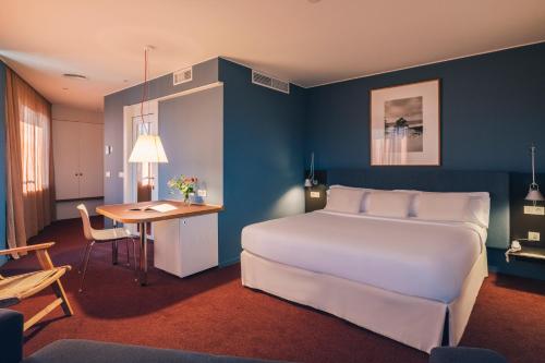圣库加特德尔瓦勒斯El Sant Cugat的酒店客房配有一张床铺、一张桌子和一张书桌。
