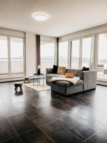 布达佩斯Highrise Horizon Penthouse的带沙发和大窗户的客厅