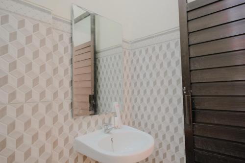 谏义里Rahayu Residence Syariah Kediri的一间带水槽和镜子的浴室