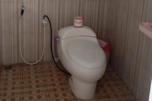 卡里蒙贾瓦Puri Karimunjawa RedPartner的浴室设有卫生间,上面有杯子