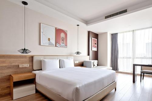 重庆重庆MontClassic精选酒店的配有一张床和一张书桌的酒店客房