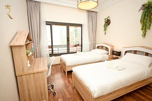 阿布扎比Beach bliss 3BR apartment Corniche的酒店客房设有两张床和窗户。
