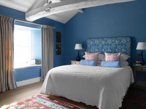 Askham4 Bed in Askham SZ264的蓝色的卧室设有床和窗户