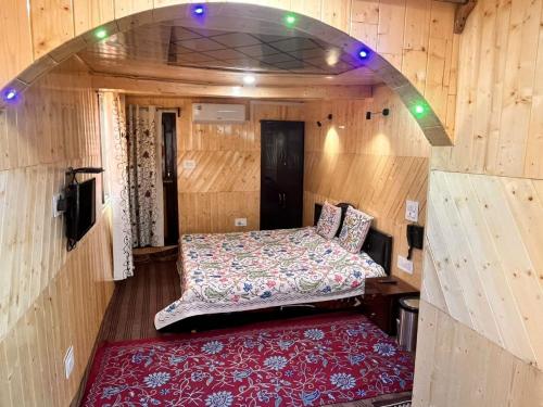 古尔马尔格Gulmarg View Cottage的小房间,配有床和红色地毯