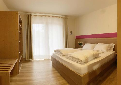 LuseveraRifugio Pian dei Ciclamini的一间卧室设有一张大床和一个窗户。