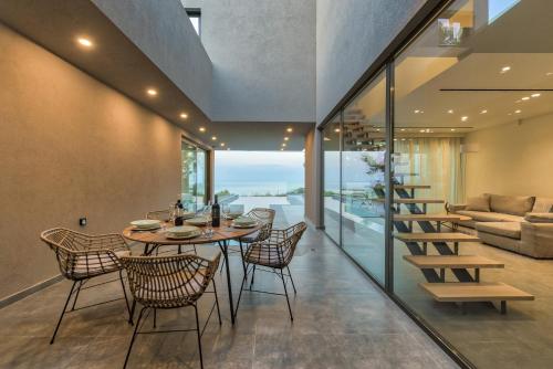 瓦西里科斯Luxury Villa Mon I Vassilikos的一间带桌椅和沙发的用餐室