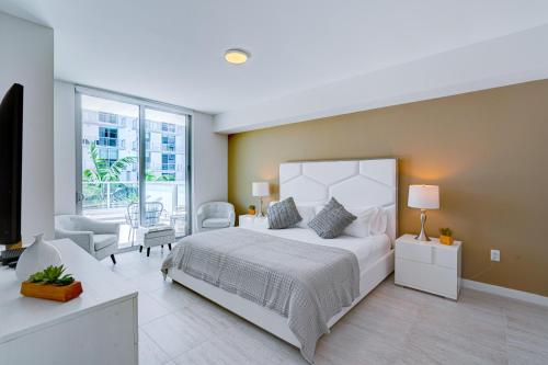 迈阿密3900-719JC DESIGN DISTRICT, CONDO 1 BEDROOM /1 BATHROOM & BAYVIE的卧室设有白色的床和大窗户