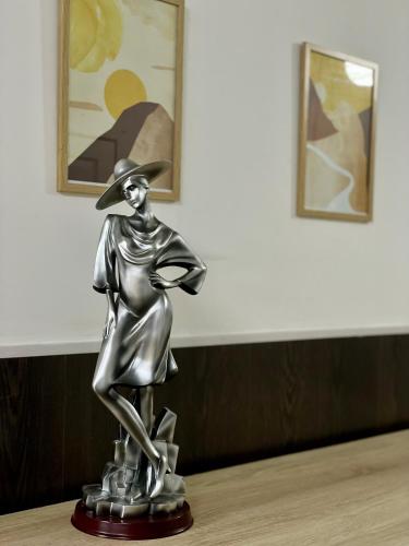 阿拉木图Парк Горького的戴帽子的女人的银雕像