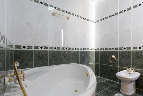 萨布盖鲁Casas do Patrão III Apartamento T2的浴室配有白色浴缸和卫生间。